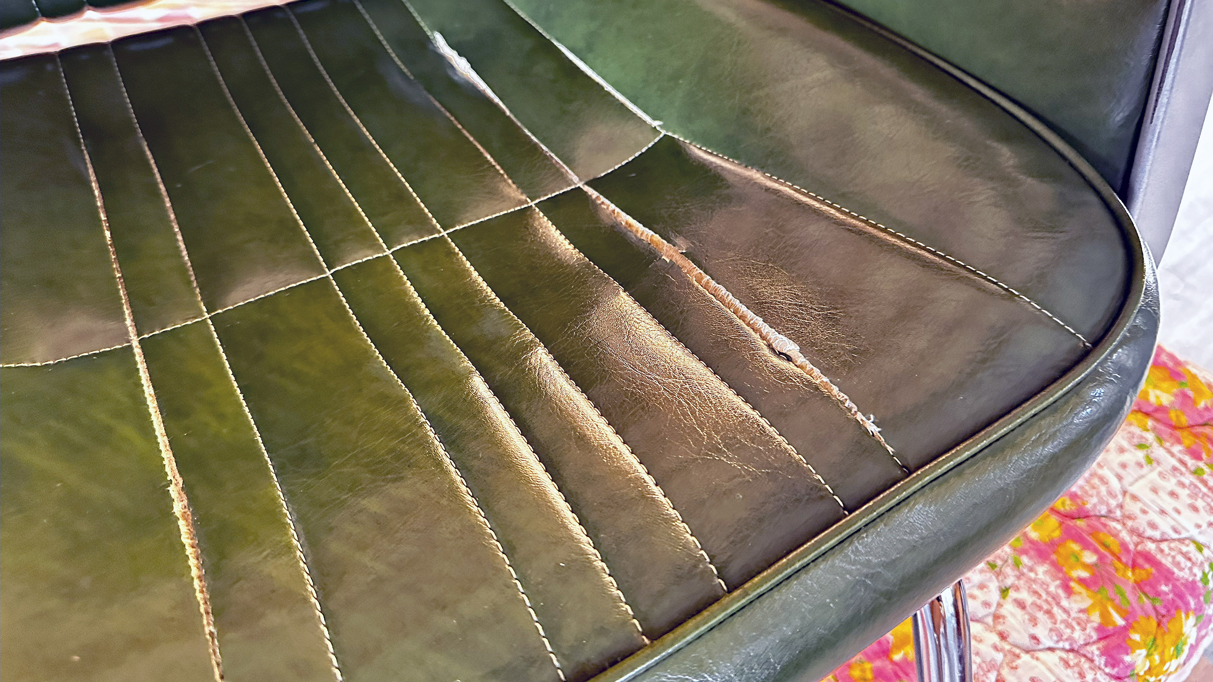 長年の使用で破れが生じた、年代物のビンテージ・スタイリングチェアー 修理前